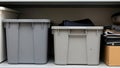 Two plastic storage bins with folded clothes and papers Royalty Free Stock Photo