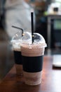 Take away cup of iced coffee mocha and iced chocolate on wood table in coffee shop Royalty Free Stock Photo