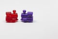 Two plastic toy trains, one red and one purple Royalty Free Stock Photo