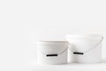 Two plastic white buckets with paints Royalty Free Stock Photo