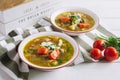 Two plates of chicken soup with vegetables, lentils and sour cream. Royalty Free Stock Photo