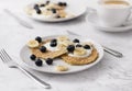 Two plates of homemade breakfast with forest fruits  and cup of coffee at marble table Royalty Free Stock Photo