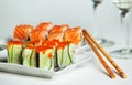 Two plates of salmon and cucumber sushi rolls Royalty Free Stock Photo