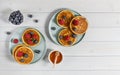 Two plates with tasty american pancakes with raspberries, blueberries, and honey. Top view, wooden table.