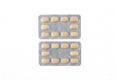 Two plates of yellow tablets on white isolated background Royalty Free Stock Photo