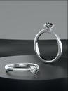 Two platinum diamond rings is placed on the black display stand, heart-shaped diamond rings design with 3D render Royalty Free Stock Photo