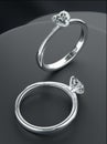 Two platinum diamond rings is placed on the black display stand, heart-shaped diamond rings design with 3D Royalty Free Stock Photo