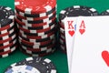 Two playing cards close-up on the background of poker chips on a green table Royalty Free Stock Photo