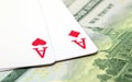 Two playing cards on dollar background. Winning poker hand. Hearts and diamonds ace on table. Royalty Free Stock Photo