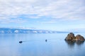 Two pleasure tourist boats sail on the water of Lake Baikal. Cape Burhan near the island of Olkhon, Russia Royalty Free Stock Photo