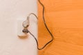Two plugs in the socket in a modern interior. Safe connection of electrical appliances concept Royalty Free Stock Photo