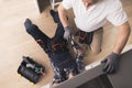 Two plumbers are prepared to repair the water filter. One of them is under the sink, the second is nearby. Royalty Free Stock Photo