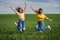 Plus size girls jumping for joy in a wheat field Royalty Free Stock Photo