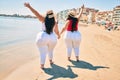 Two plus size overweight sisters twins women happy at the beach on summer holidays Royalty Free Stock Photo