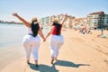 Two plus size overweight sisters twins women happy at the beach on summer holidays Royalty Free Stock Photo