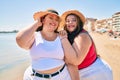 Two plus size overweight sisters twins women happy at the beach on summer holidays Royalty Free Stock Photo