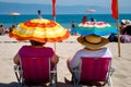 Two plus size overweight sisters twins women happy and proud of their bodies walking at the beach on summer holidays Royalty Free Stock Photo