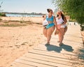 Two plus size overweight sisters twins women walking at the beach on summer holidays