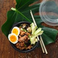 Two poke bowl fried rice chicken meat eggs box top view Asian take away food Royalty Free Stock Photo