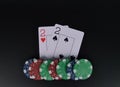 Two poker deuces on black table with chips on black background Royalty Free Stock Photo