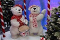 Two polar bears stand under a tree in a red scarf and hat. One bear is dancing and the other with a drum. Bears in Christmas Royalty Free Stock Photo