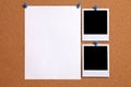 Two polaroid style blank photo frames with paper poster pinned to cork notice board, copy space