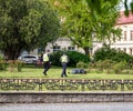 Two Police Officers attending to a drunk man lying on a city pavement in Uzhhorod Royalty Free Stock Photo