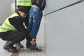 Police officers detaining a drug dealer, copy space on the empty grey wall