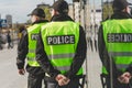 Police officers in reflective vests patrol the streets of the city