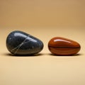 Two polished stones are displayed on a smooth, neutral background Royalty Free Stock Photo