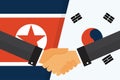 Two politicians handshake in front of an South and North Korean flags. Two flags face to face, symbol for the