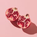 Ripe Pomegranate Halves on Pink Background Royalty Free Stock Photo