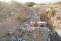 Two poor refugee children boy girl on ruins building destroyed by air strike