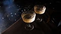 Two popular vintage champagne glasses on a dark background of the served table Royalty Free Stock Photo