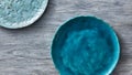 Two porcelain blue bowls on a gray wooden table. Multi-colored ceramic vintage handmade dishes. Top view. Royalty Free Stock Photo