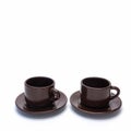 Two porcelain coffee cups and saucers stand side by side. Royalty Free Stock Photo