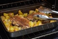 Two pork entrecotes with potatoes baked in the oven. Homemade food in the oven. Baked meat with vegetables. Pork meat in the oven