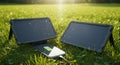 Two portable solar panels are displayed open on grass, angled towards the sunlight.