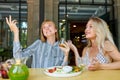 Two positive caucasian women enjoy spending time together in restaurant Royalty Free Stock Photo