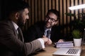 Two positive confident businessmen shaking hands over meeting table after negotiation, closing deal, contract, agreement Royalty Free Stock Photo