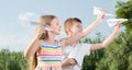 two positive kids playing with simple paper planes Royalty Free Stock Photo