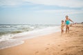 Two positive little girls run along sandy beach Royalty Free Stock Photo