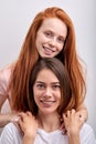 Two positive women lesbian couple hugging looking at camera, close up portrait Royalty Free Stock Photo