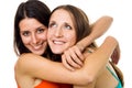 Two positive young woman smile hug