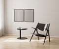 two poster frames mockup on white wall, black chair and coffee table, 3d render Royalty Free Stock Photo