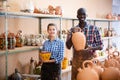 Two potters posing in pottery workshop