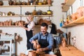 Two potters working with ceramics in atelier.