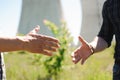 Two power line tower workers with handshaking. Royalty Free Stock Photo