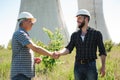 Two power line tower workers with handshaking. Royalty Free Stock Photo