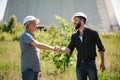 Two power line tower workers with handshaking. Royalty Free Stock Photo